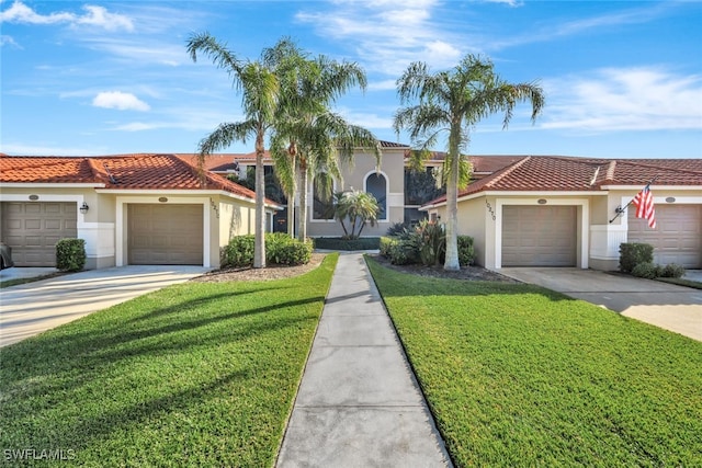 mediterranean / spanish home with a garage and a front lawn