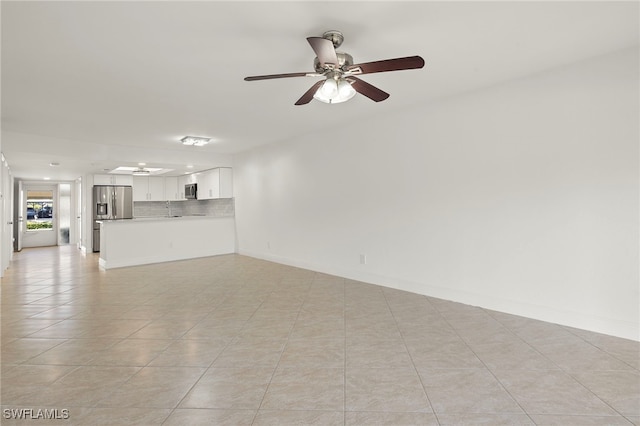 unfurnished living room with ceiling fan and light tile patterned flooring