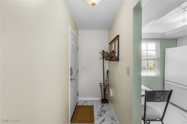 hallway with a textured ceiling