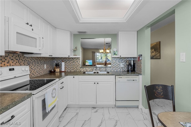 kitchen with white cabinetry, white appliances, sink, and tasteful backsplash