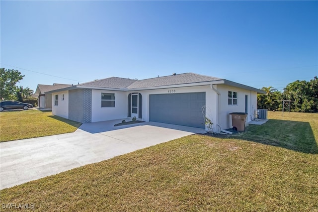 ranch-style house with central AC, a garage, and a front lawn