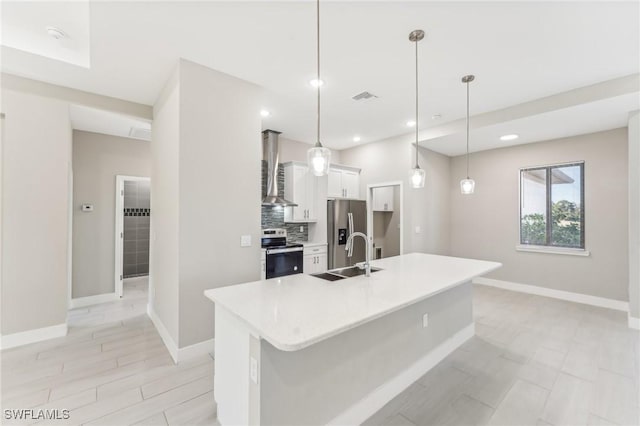 kitchen with pendant lighting, white cabinets, sink, appliances with stainless steel finishes, and a large island