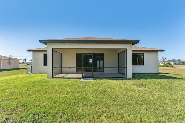 rear view of house featuring a yard