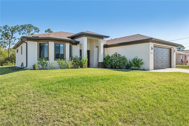 view of front of house with a front lawn and a garage