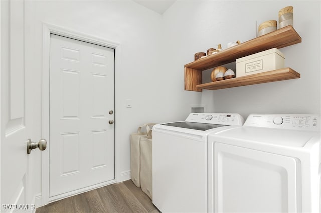 laundry area featuring washer and dryer and light hardwood / wood-style flooring