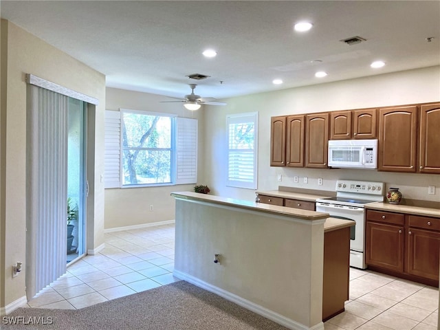 kitchen featuring ceiling fan, white appliances, and light tile patterned floors