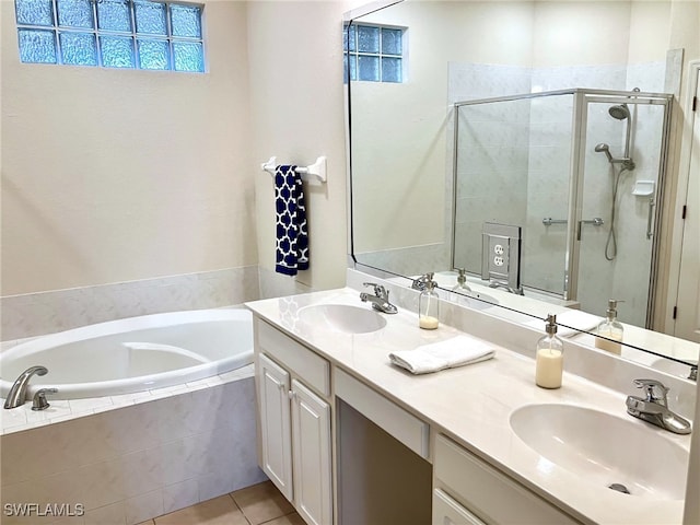 bathroom featuring tile patterned floors, vanity, and shower with separate bathtub