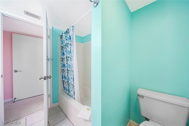 bathroom featuring tile patterned flooring, shower / bath combination with curtain, and toilet