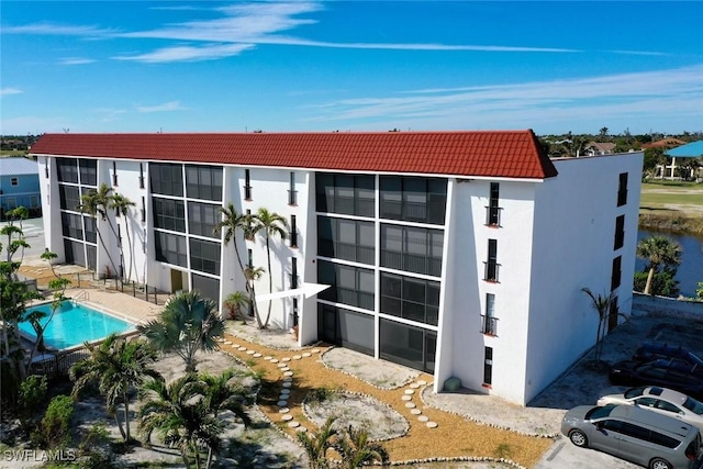 rear view of house featuring a community pool