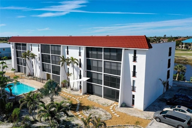 1440 Middle Gulf Dr Unit 2E, Sanibel, FL 33957 - view of building exterior with a community pool
