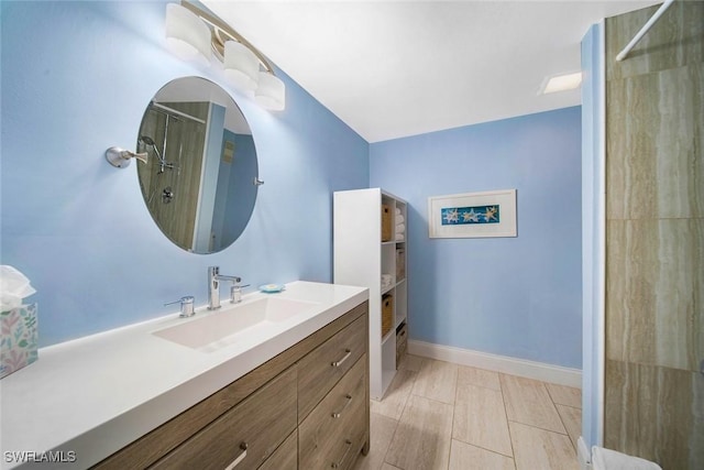 1440 Middle Gulf Dr Unit 2E, Sanibel, FL 33957 - bathroom with vanity, a shower, and baseboards