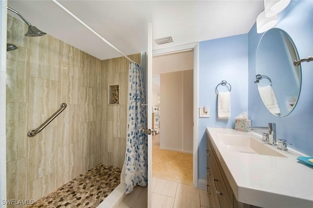 1440 Middle Gulf Dr Unit 2E, Sanibel, FL 33957 - bathroom featuring a tile shower, tile patterned floors, and vanity