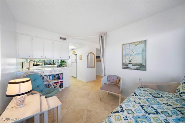 tiled bedroom with white refrigerator