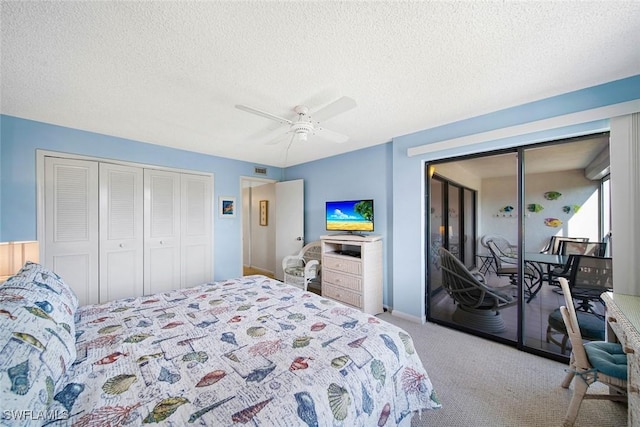 carpeted bedroom with ceiling fan, a textured ceiling, and a closet