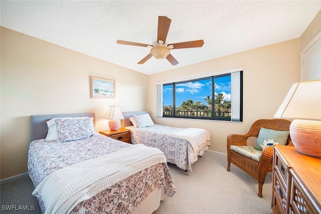 bedroom featuring ceiling fan, carpet floors, and a textured ceiling