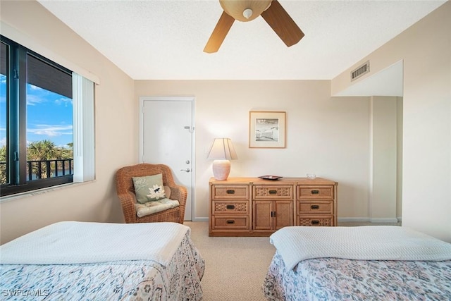 bedroom with ceiling fan and light carpet