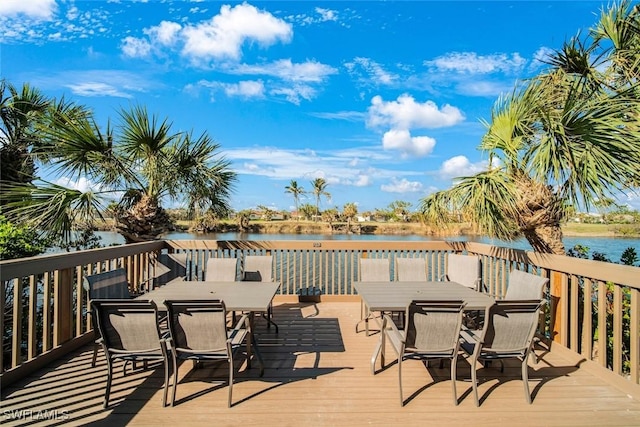 1440 Middle Gulf Dr Unit 2E, Sanibel, FL 33957 - wooden terrace with outdoor dining space and a water view