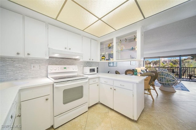 kitchen with kitchen peninsula, white cabinetry, light tile patterned flooring, and white appliances