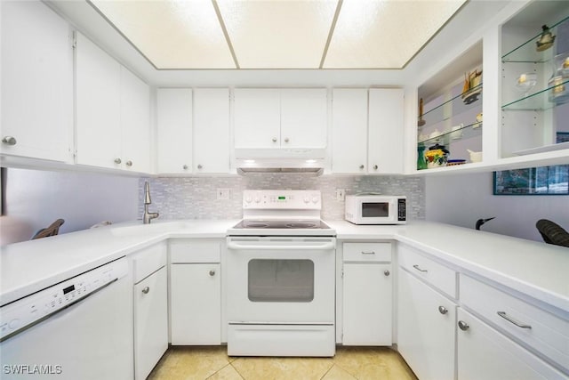 kitchen featuring light tile patterned floors, white appliances, white cabinetry, and sink