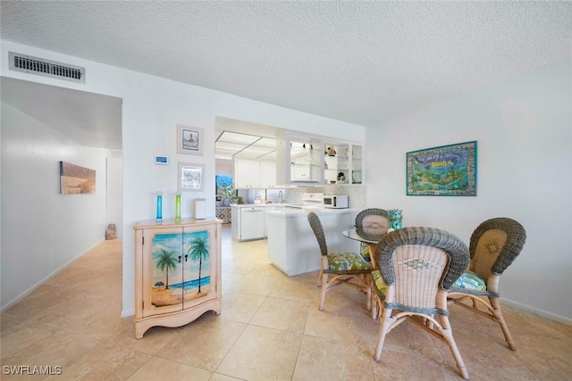 tiled living room with a textured ceiling