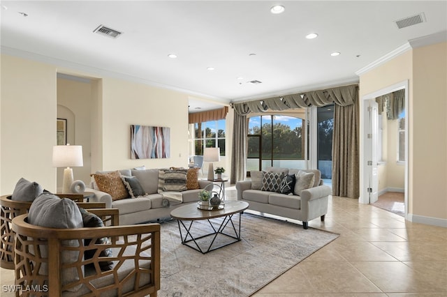 living room with ornamental molding and light tile patterned floors