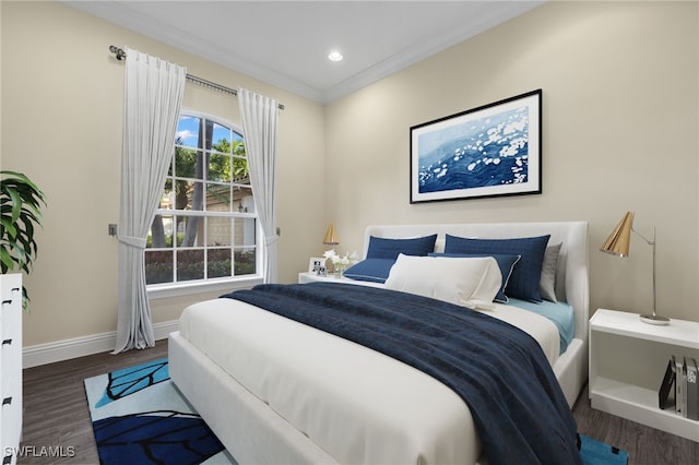 bedroom with dark hardwood / wood-style floors and ornamental molding