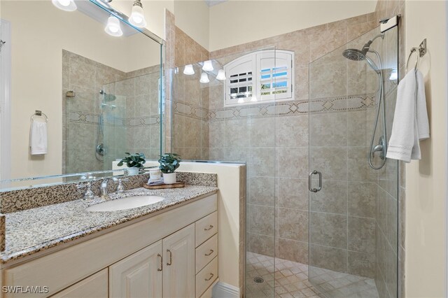 bathroom featuring vanity and an enclosed shower