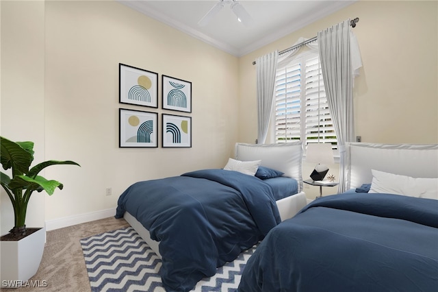 carpeted bedroom featuring ceiling fan and ornamental molding