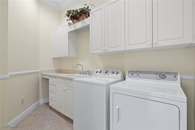 laundry room with sink, cabinets, washing machine and dryer, crown molding, and light tile patterned flooring