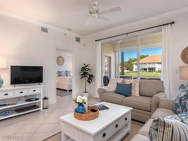 living room with ceiling fan, light tile patterned floors, and crown molding