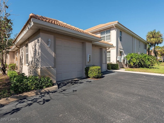 view of side of home featuring a garage