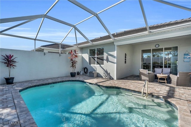 view of swimming pool featuring glass enclosure and a patio