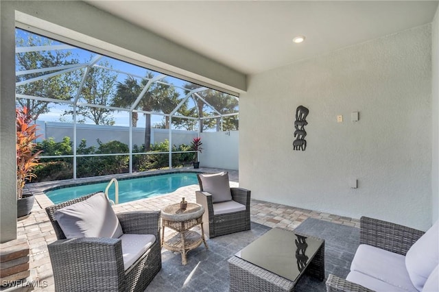 view of swimming pool with a patio and a lanai