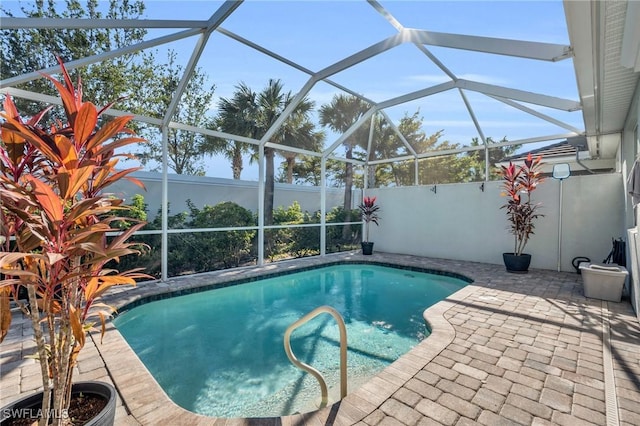 view of swimming pool with a patio and a lanai