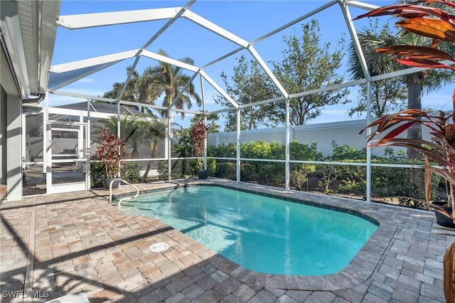 view of swimming pool with a lanai and a patio