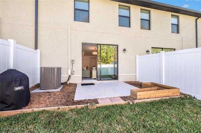 rear view of house featuring cooling unit and a patio