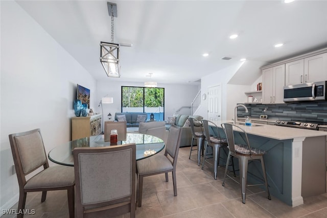 dining area with light tile patterned floors and sink