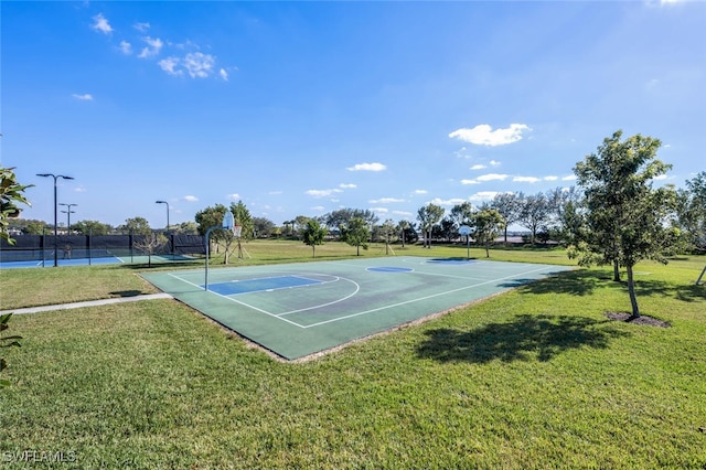 view of sport court with a yard and tennis court