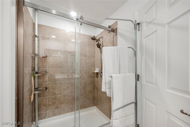 bathroom featuring a shower with door