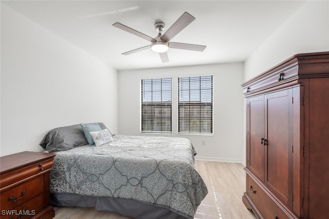 bedroom with ceiling fan and light hardwood / wood-style floors