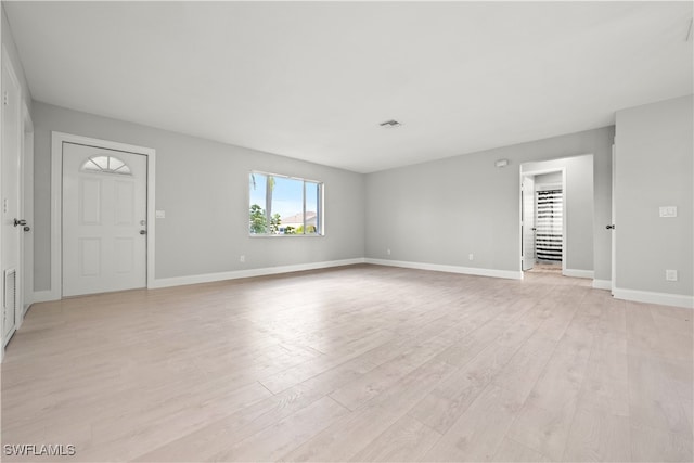 unfurnished room with light wood-type flooring