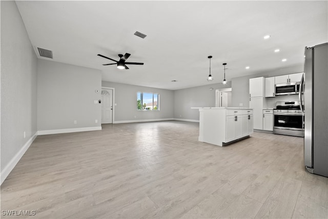 kitchen with stainless steel appliances, ceiling fan, light hardwood / wood-style floors, white cabinetry, and hanging light fixtures