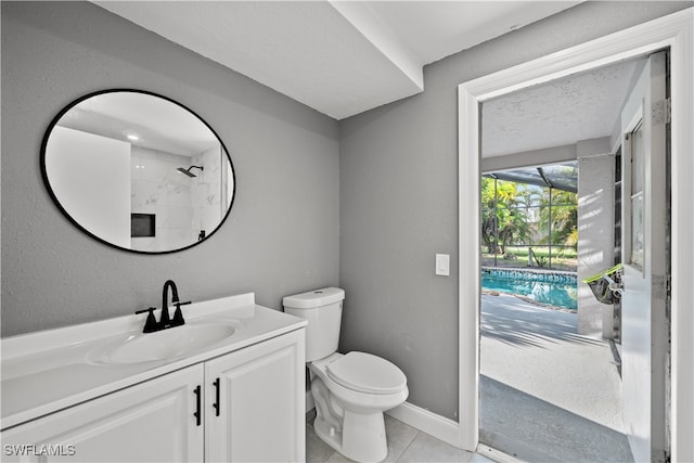 bathroom with tile patterned flooring, vanity, toilet, and walk in shower