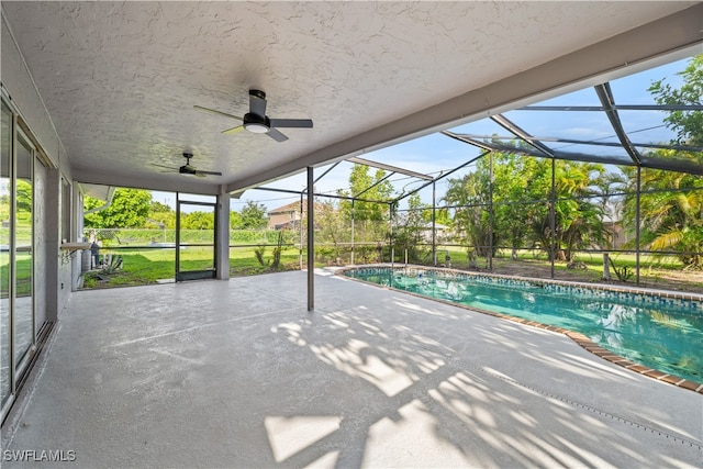 view of pool featuring a patio area, ceiling fan, and a lanai