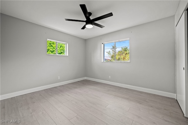 unfurnished room with light hardwood / wood-style flooring, plenty of natural light, and ceiling fan