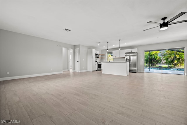 unfurnished living room with light hardwood / wood-style floors and ceiling fan