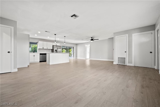 unfurnished living room featuring light wood-type flooring and ceiling fan