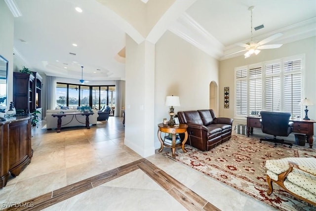 living room featuring ceiling fan, plenty of natural light, and ornamental molding