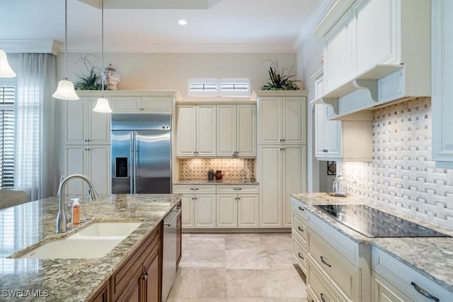 kitchen with decorative light fixtures, a healthy amount of sunlight, sink, and appliances with stainless steel finishes