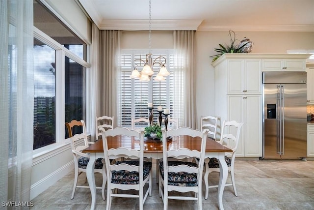 dining space featuring crown molding and a chandelier